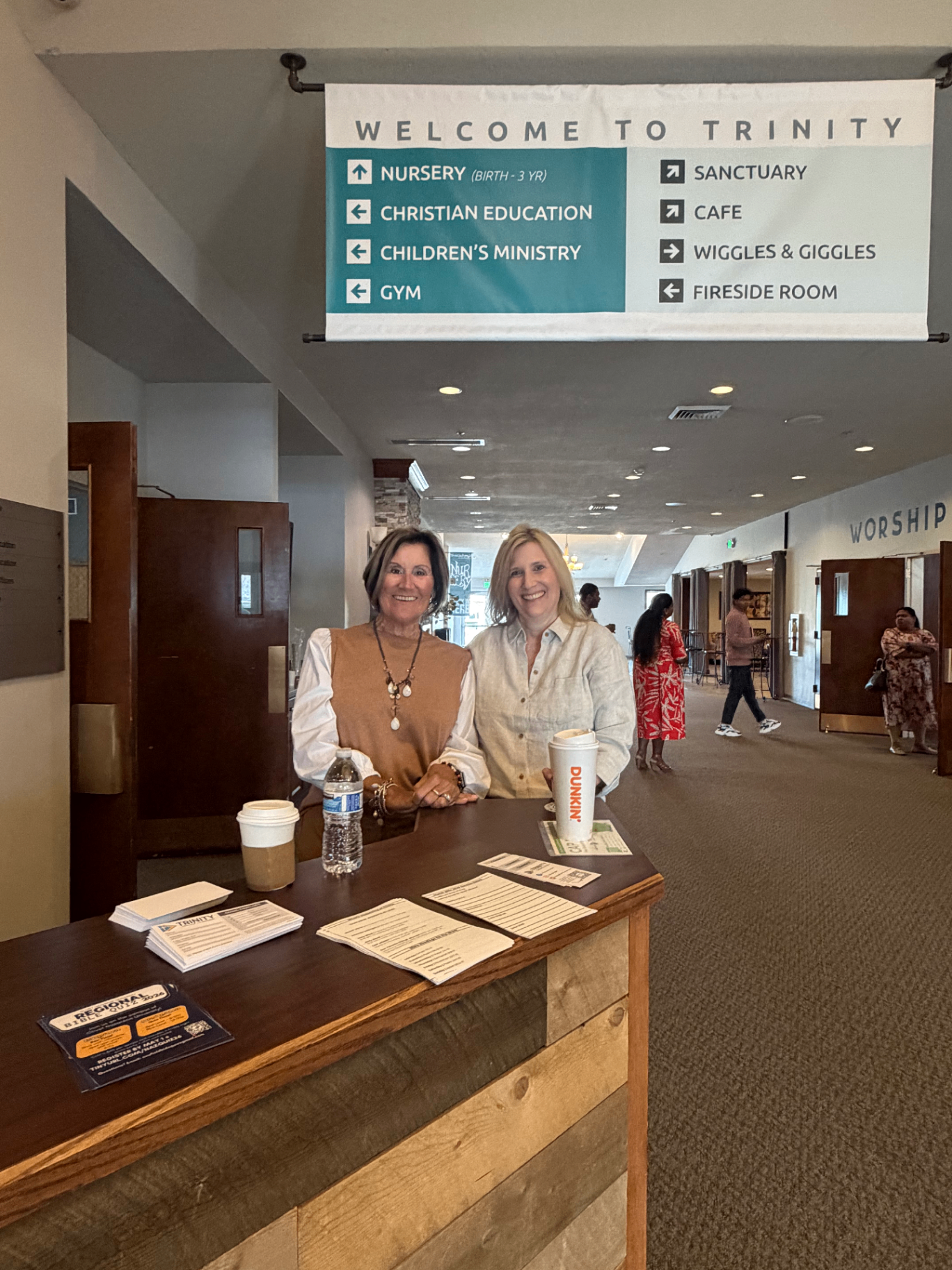 Friendly greeters welcoming visitors at Trinity Church
